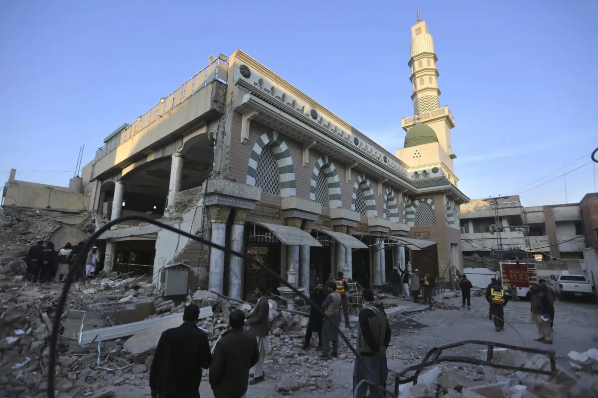 People visit at the site of Monday's suicide bombing after authorities finished the rescue operation in Peshawar, Pakistan, on Jan. 31, 2023. (Muhammad Sajjad/AP Photo)