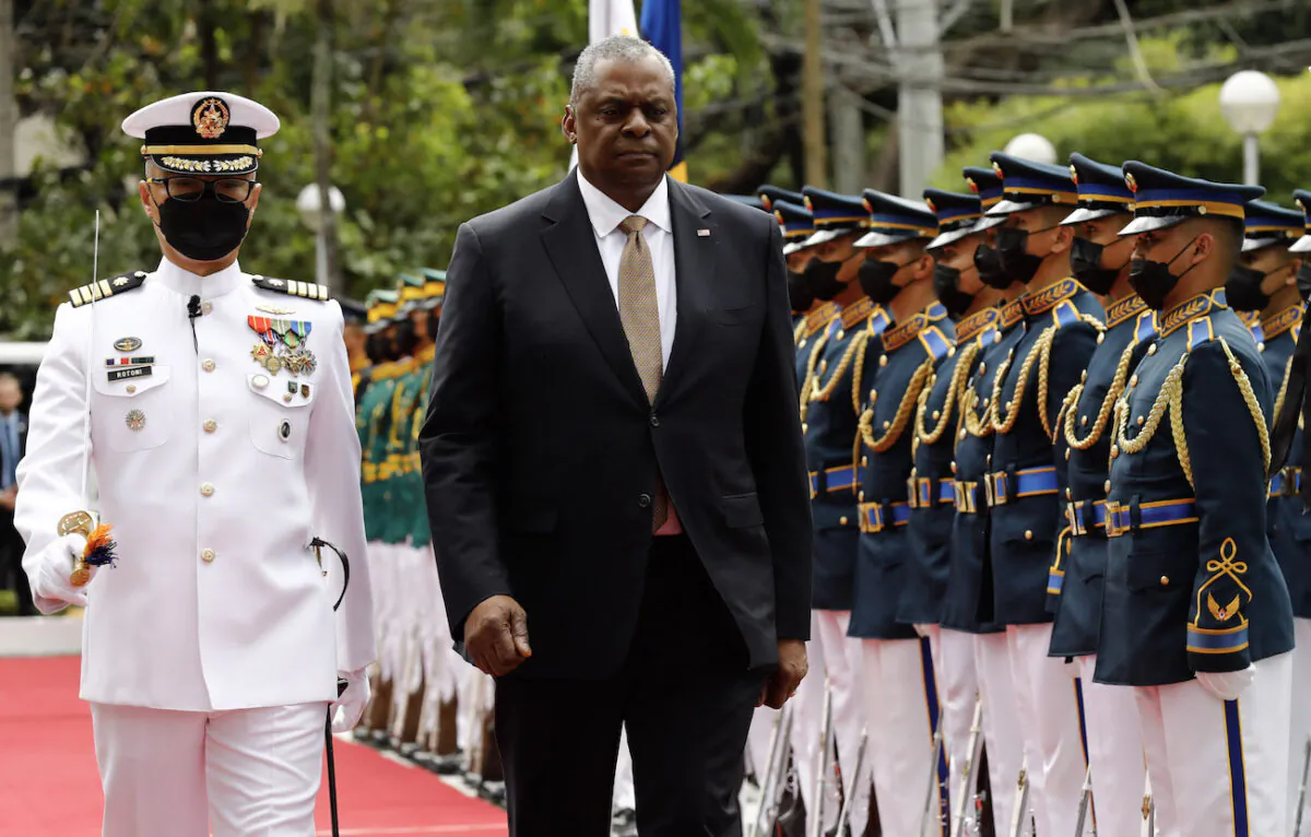 U.S. Defense Secretary Lloyd Austin (R) walks past military guards during arrival honors at the Department of National Defense in Camp Aguinaldo military camp in Quezon City, Manila, Philippines, on Feb. 2, 2023. (Rolex Delapena-Pool/Getty Images)