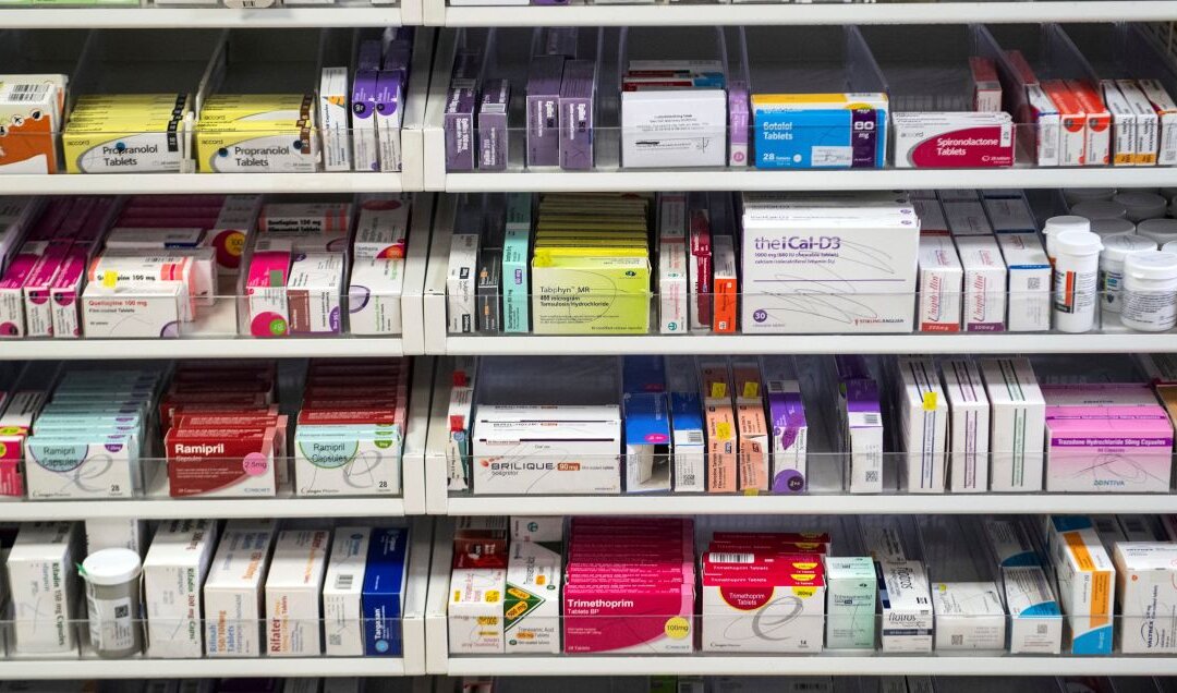 A file photo shows medications displayed on shelves. (Andy Buchanan/POOL/AFP via Getty Images)