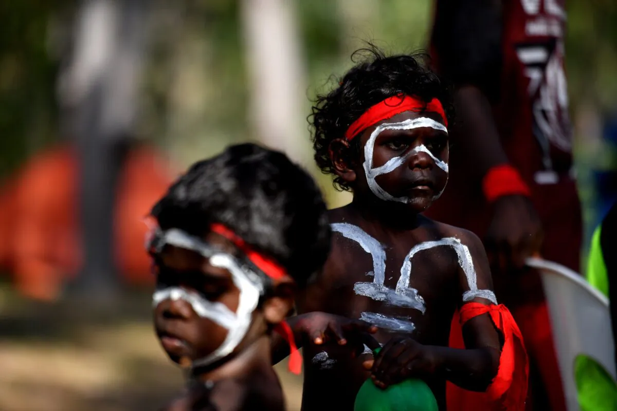 Children of the Yolngu people from north-eastern Arnhem Land prepare to perform the Bunggul traditional dance during the Garma Festival near Nhulunbuy, East Arnhem Land, in Australia, on Aug. 4, 2018. (AAP Image/Mick Tsikas)