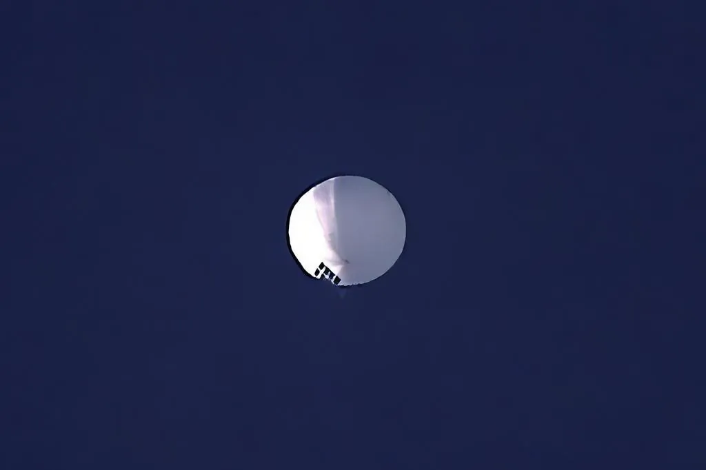 A high altitude balloon floats over Billings, Mont., on Feb. 1, 2023. The U.S. is tracking a suspected Chinese surveillance balloon that has been spotted over U.S. airspace for a couple days, but the Pentagon decided not to shoot it down due to risks of harm for people on the ground, officials said on Feb. 2, 2023.  (Larry Mayer/The Billings Gazette via AP)
