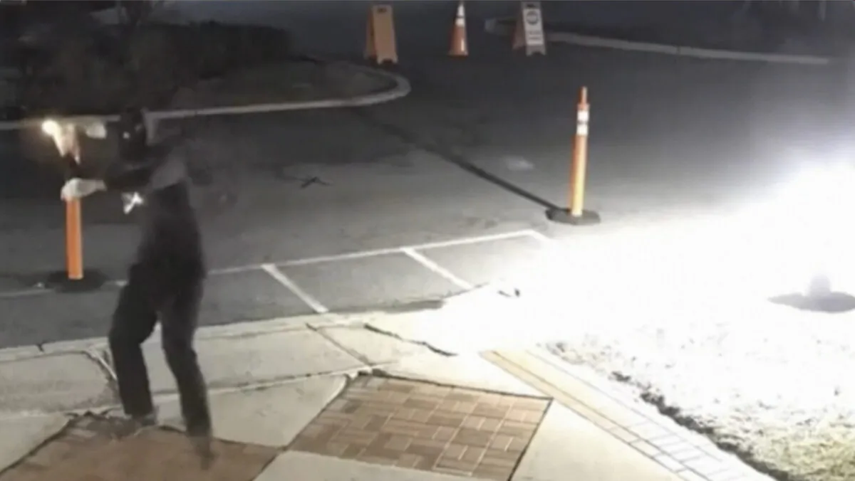 A still from surveillance camera video shows a man throwing Molotov cocktail at Temple Ner Tamid in Bloomfield, N.J., on Jan. 29, 2023. (Temple Ner Tamid via AP/Screenshot via The Epoch Times)