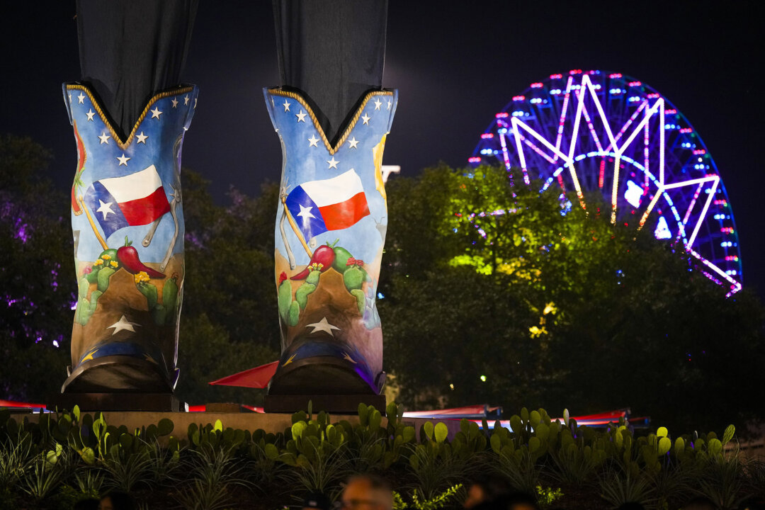 The Texas Star is seen behind the size 96 Lucchese boots of Big Tex on opening night at the State Fair of Texas on Friday, Sept. 30, 2022, in Dallas. (Smiley N. Pool/The Dallas Morning News/TNS)