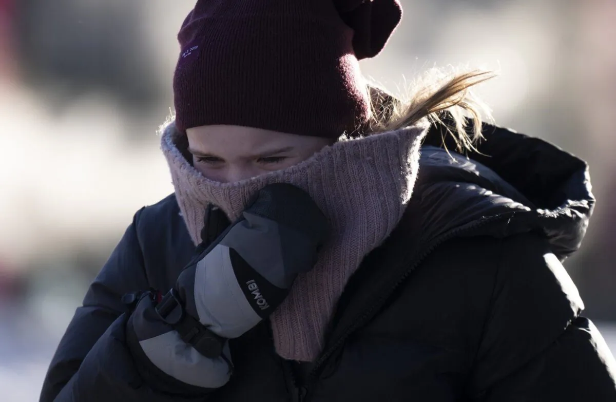 As an immense Arctic air mass settled over the eastern half of Canada today, Environment Canada issued an unusually long list of extreme cold warnings that covered six provinces and communities in both territories. A person tries to stay warm as they walk in downtown Ottawa, Feb. 3, 2023. (The Canadian Press/Adrian Wyld)