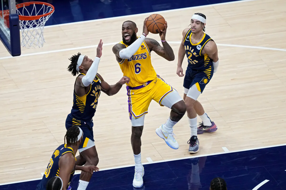LeBron James (6) of the Los Angeles Lakers attempts a shot while being guarded by Buddy Hield (24) of the Indiana Pacers in the fourth quarter at Gainbridge Fieldhouse in Indianapolis on Feb. 2, 2023.(Dylan Buell/Getty Images)