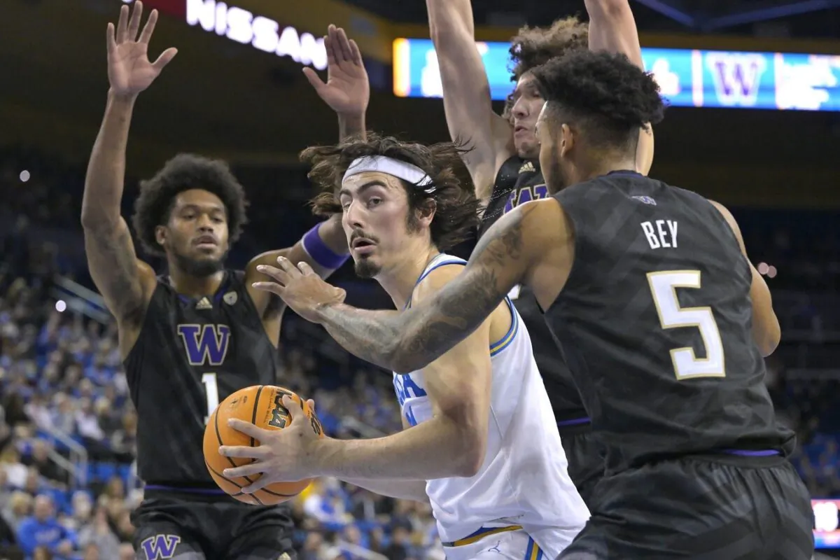 UCLA Bruins guard Jaime Jaquez Jr. (24) is defended under the basket by Washington Huskies guard Jamal Bey (5) and forward Keion Brooks (1) in the first half at Pauley Pavilion presented by Wescom in Los Angeles, on Feb. 2, 2023. (ayne Kamin-Oncea/USA TODAY Sports via Field Level Media)