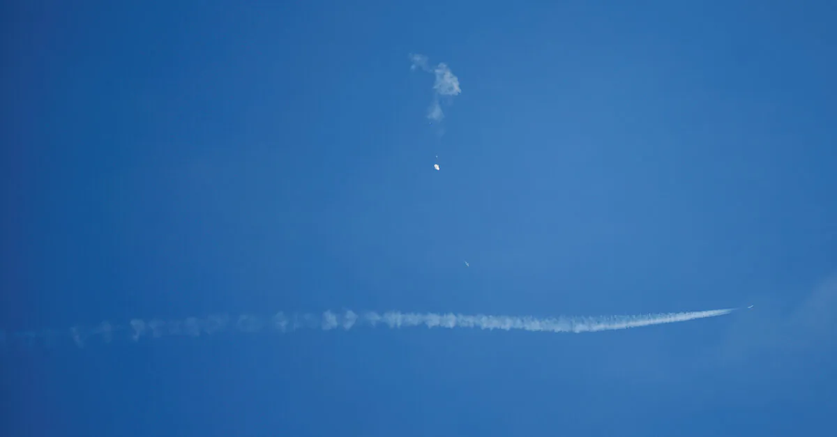 A jet flies by a Chinese spy balloon after shooting it down off the coast in Surfside Beach, S.C., on Feb. 4, 2023. (Randall Hill/Reuters)