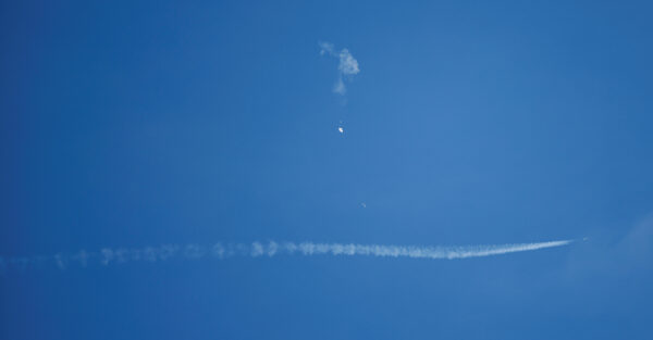 A jet flies by a suspected Chinese spy balloon after shooting it down off the coast in Surfside Beach, South Carolina, U.S. February 4, 2023. REUTERS/Randall Hill