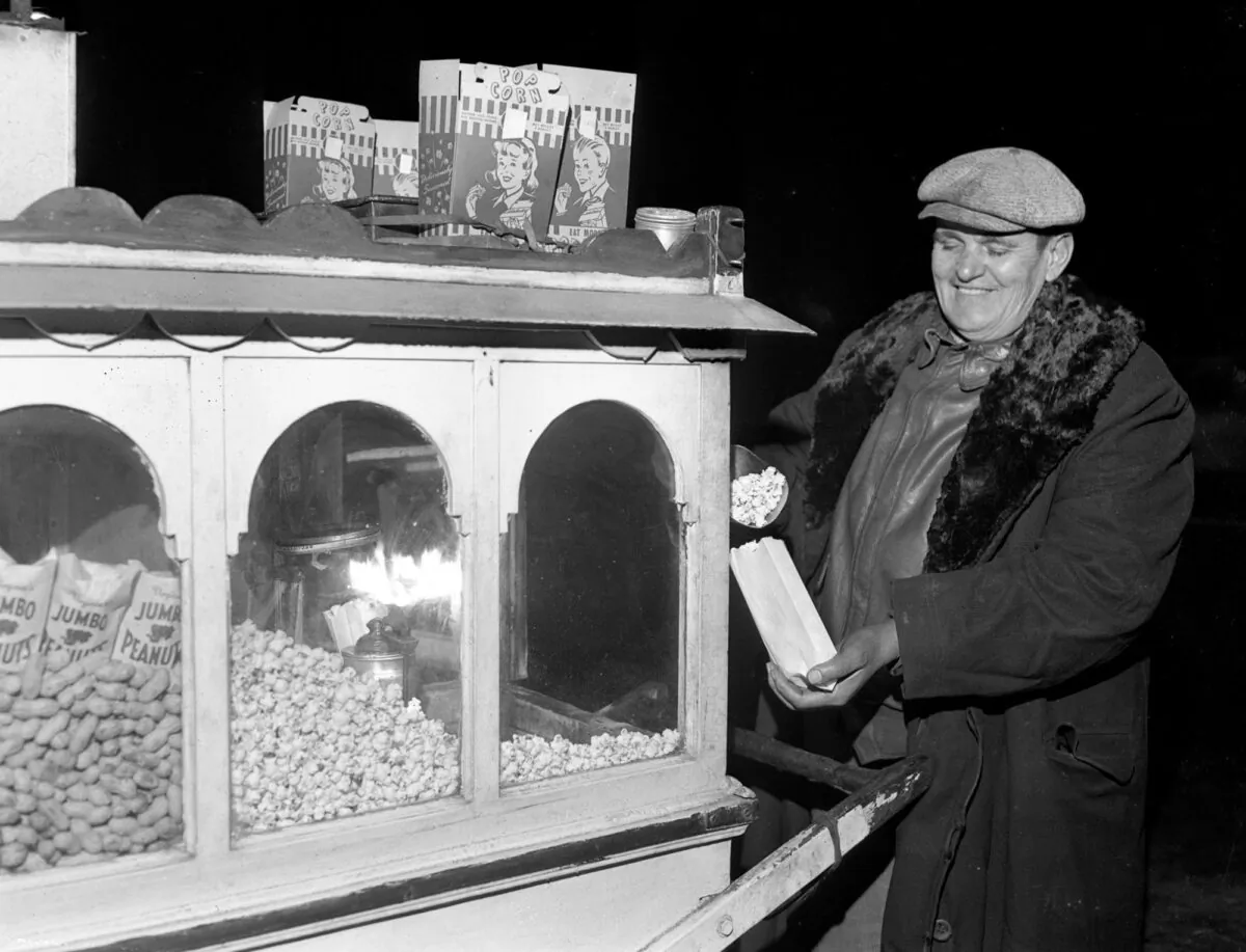 John Spiropoulos doesn't let a coal strike bother his peanut and popcorn business as he uses gasoline for light and heat at North Avenue and Clark Street on Nov. 25, 1946, in Chicago. (Howard Borvig/Chicago Tribune/TNS)