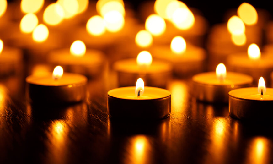 Many burning candles with concept of mourning the dead from the COVID-19 in China. (Vladyslav Starozhylov/Shutterstock).