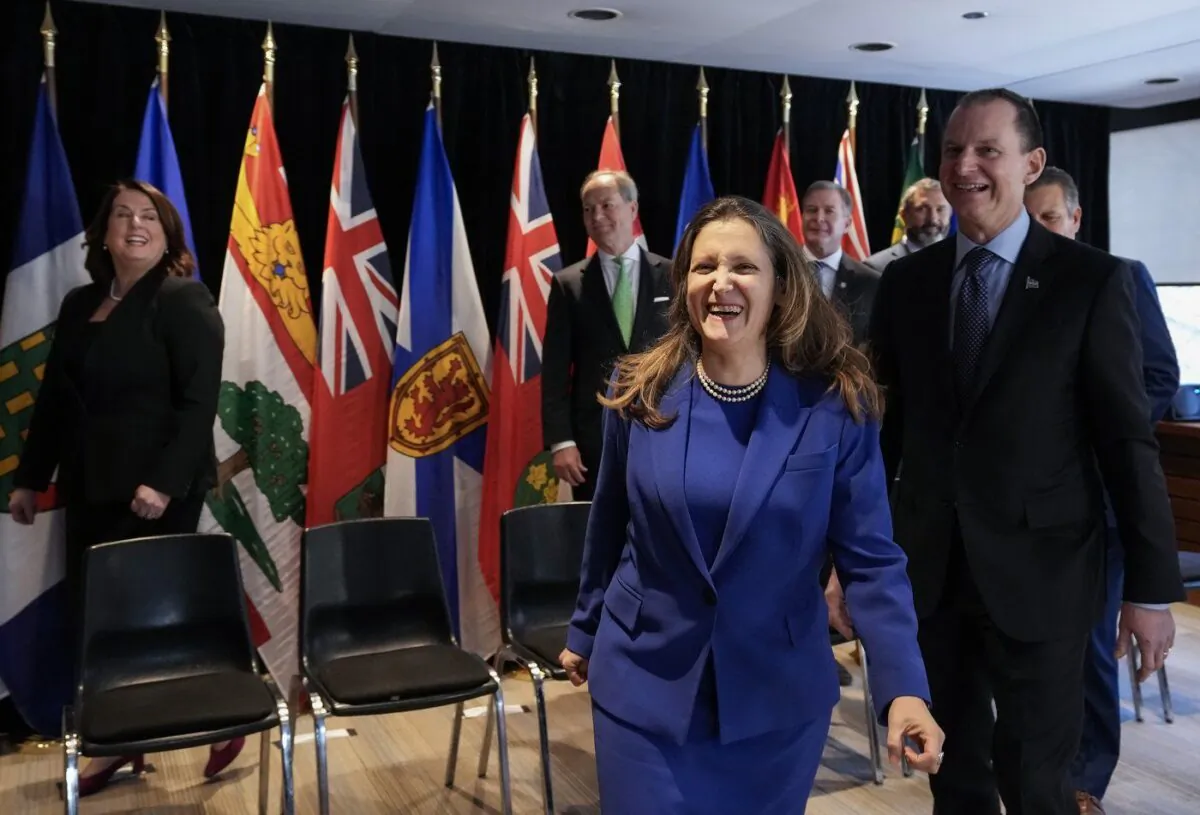 Chrystia Freeland, centre, Canada’s Deputy Prime Minister and Minister of Finance laughs next to Eric Girard, right, Minister of Finance of Quebec after a group photograph during the Finance Ministers' Meeting in Toronto, on Feb. 3, 2023. (The Canadian Press/Nathan Denette)