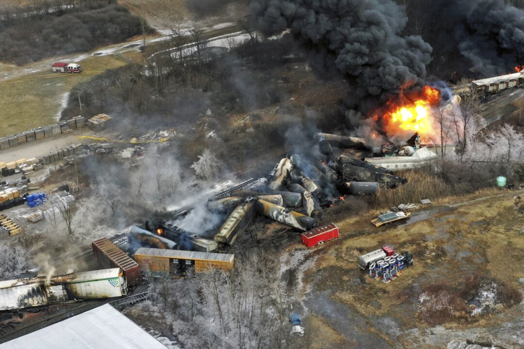 Portions of a Norfolk and Southern freight train that derailed Friday night in East Palestine, Ohio, are still on fire at mid-day, on Feb. 4, 2023. (Gene J. Puskar/AP Photo)
