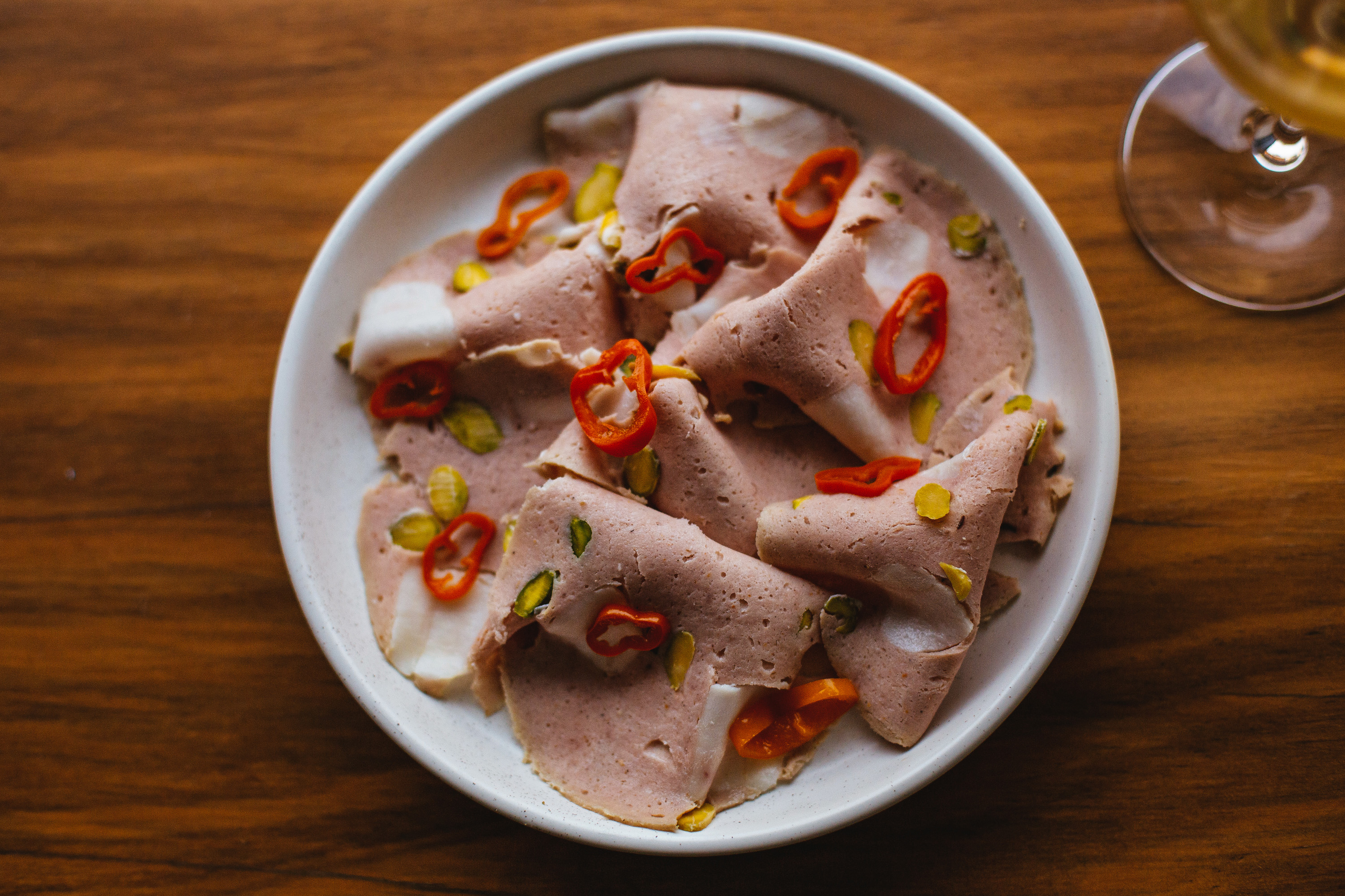 mortadella on a plate with peppers