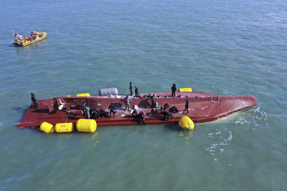 Members of the rescue team search for people from a capsized boat in waters off the country's southwestern coast in South Korea on Feb. 5, 2023. (Jung Hee-sung/Yonhap via AP)