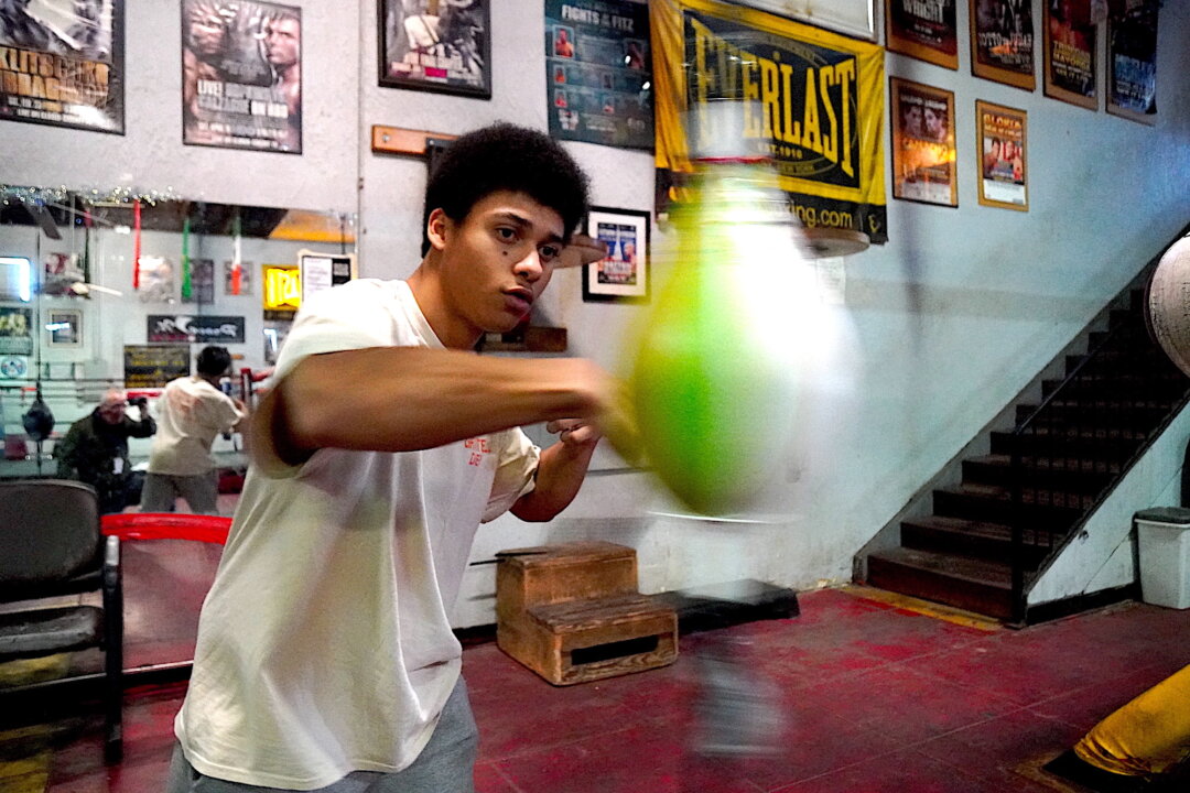 Amateur boxer Brian Viera, 20, works out on the punching bag at Central Boxing Gym in Phoenix, Ariz., on Jan. 26, 2023. (Allan Stein/The Epoch Times)