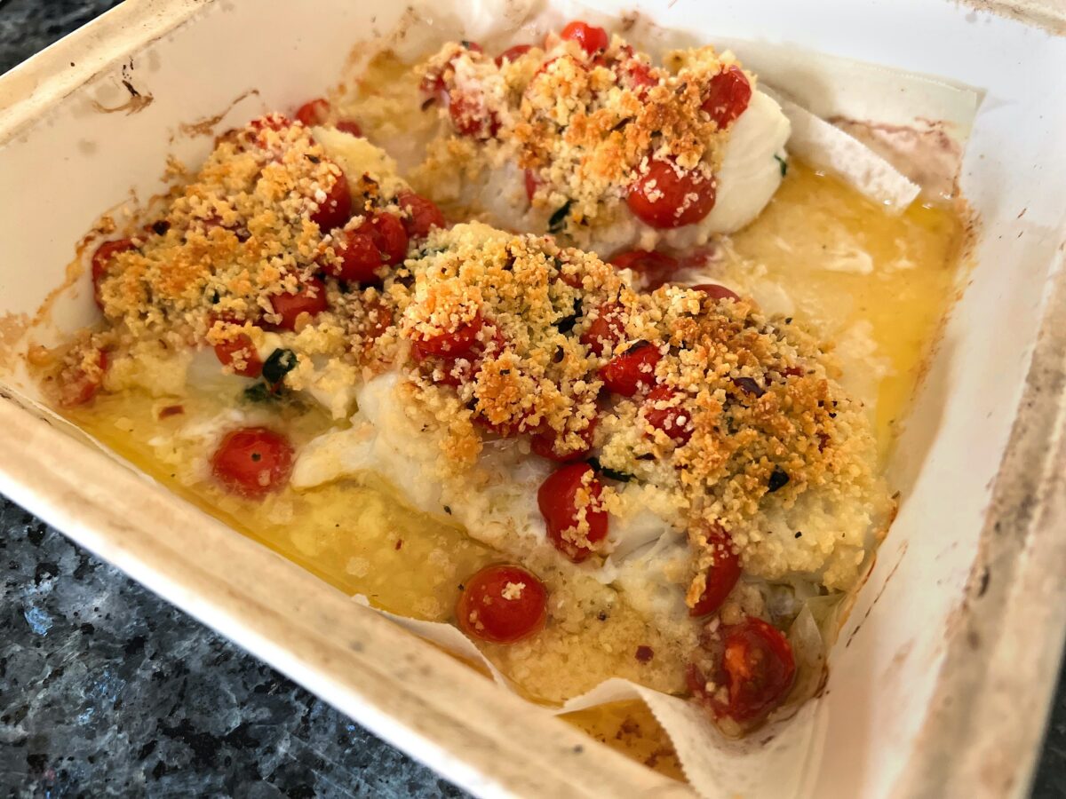 Baked cod is topped with lemon butter, garlicky tomatoes and a Parmesan-panko crust for a simple, but satisfying, supper. (Gretchen McKay/Pittsburgh Post-Gazette/TNS)