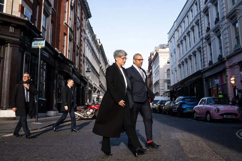 Britain's Foreign Secretary James Cleverly (R) and Australian Foreign Minister Penny Wong walk through central London on their way to Australia House after holding a meeting at the Foreign Secretary's official residence at Carlton Gardens in London, on Feb. 1, 2023. (Stefan Rousseau/POOL/AFP via Getty Images)