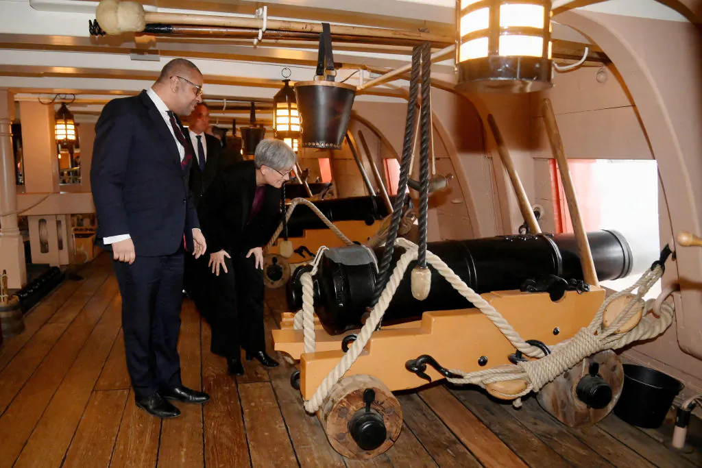 Australia's Foreign Minister Penny Wong and British Foreign Secretary James Cleverly view a cannon on the gun deck of British warship HMS Victory during Australia-United Kingdom Ministerial Consultations, in Portsmouth, England, on Feb. 2, 2023. (Toby Melville/WPA Pool/Getty Images)