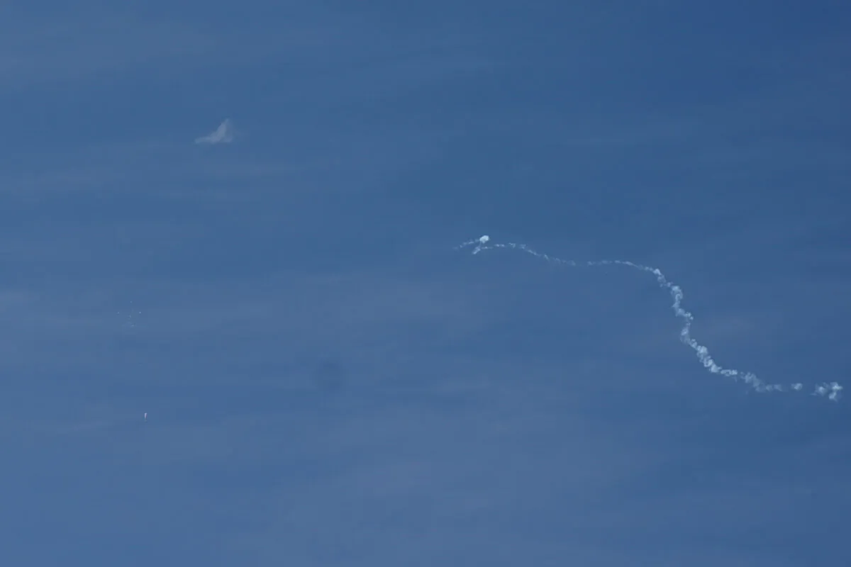 A view of what is believed to be a Chinese spy balloon when it was shot down, seen from Holden Beach, N.C., on Feb. 4, 2023. (Allison Joyce/Reuters)