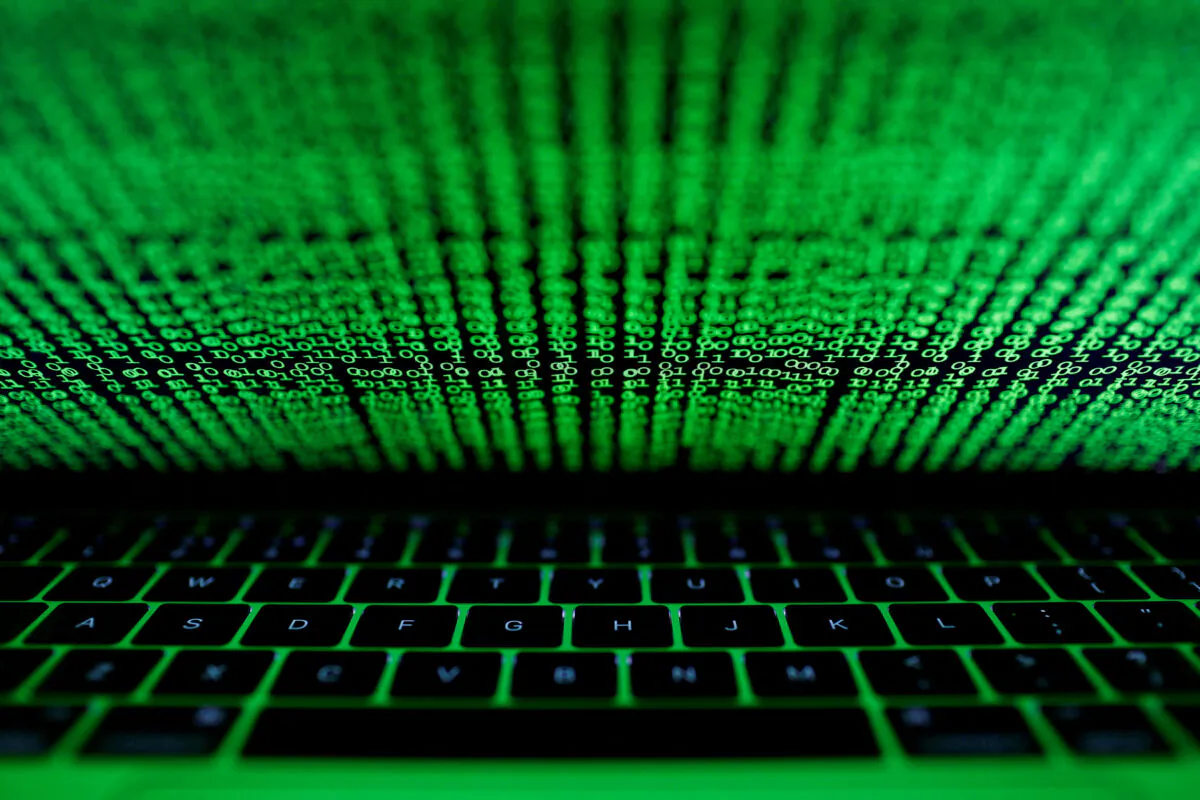 A computer keyboard is lit by a displayed cyber code in this picture taken on March 1, 2017. (Kacper Pempel/Illustration/Reuters)