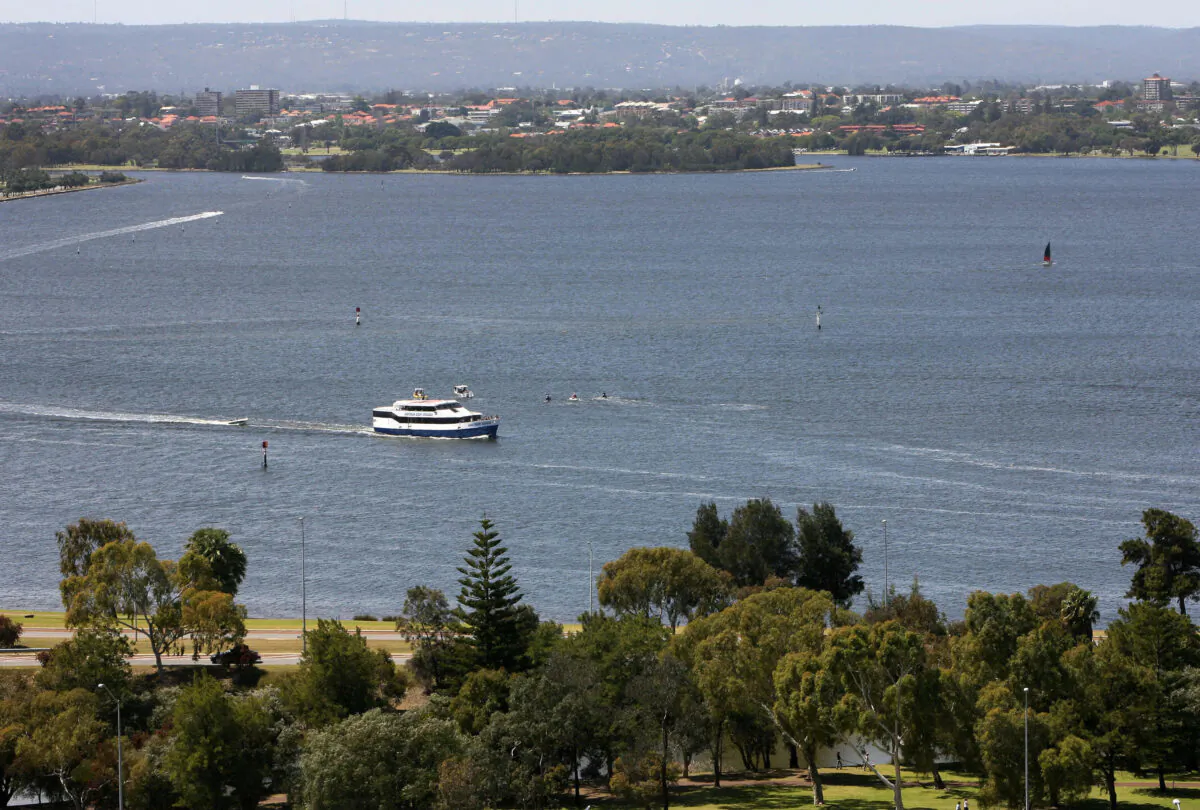A boat (C) cruises on Swan River in Perth, Australia, on Oct. 15, 2006. (Greg Wood/AFP via Getty Images)
