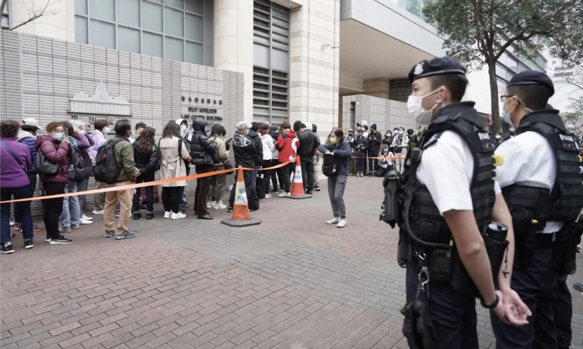 The 47 HK pro-democracy activists alleged to be involved in organizing and participating in a "primary election" and charged with "conspiracy to subvert state power," have been remanded nearly 2 years since their first court appearance in March 2021. Sixteen of them who have pleaded not guilty resume their trial in the West Kowloon Magistrates' Court on Feb. 6. The picture shows more than 100 citizens queued outside the court waiting for entry in the early morning hours. Feb. 6, 2023. (Adrian Yu/The Epoch Times)