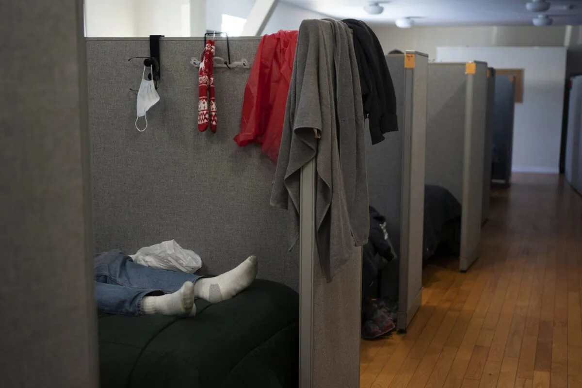 A person lays on a bed in the North Park Street emergency shelter in Halifax on Feb. 4, 2023. (The Canadian Press/Darren Calabrese)