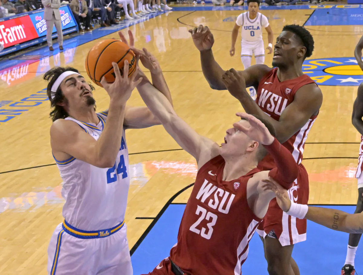 Jaime Jaquez Jr. (24) of the UCLA Bruins grabs a rebound in front of Andrej Jakimovski (23) and Mouhamed Gueye (35) of the Washington State Cougars in the first half at UCLA Pauley Pavilion in Los Angeles on Feb. 4, 2023. (Jayne Kamin-Oncea/Getty Images)