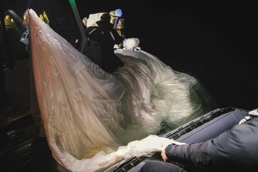 Sailors are seen attempting to recover a high-altitude surveillance balloon off the coast of Myrtle Beach, South Carolina, Feb. 5, 2023. (U.S. Navy Photo by Mass Communication Specialist 1st Class Tyler Thompson)