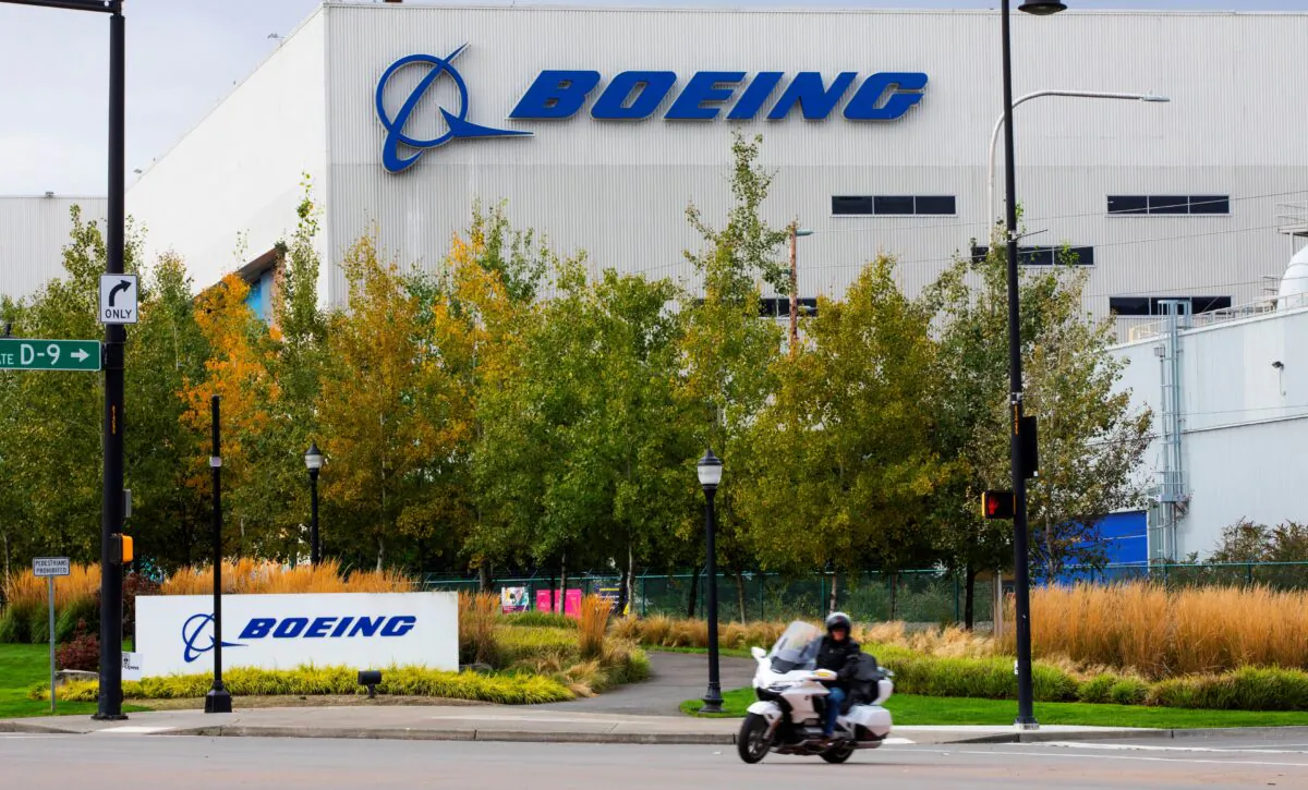 A motorcyclist cruises past the Boeing plant in Renton, Wash., on Oct. 28, 2020. (Ellen M. Banner/The Seattle Times via AP)