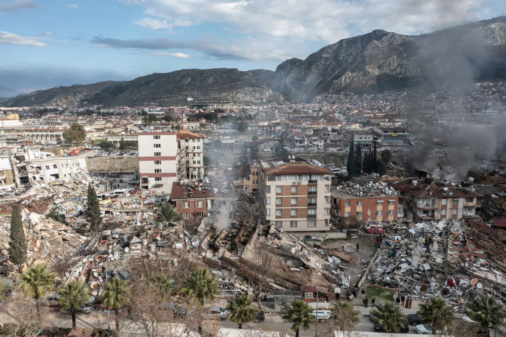 Smoke billows from the scene of a collapsed buildings in Hatay, Turkey, on Feb. 7, 2023. (Burak Kara/Getty Images)