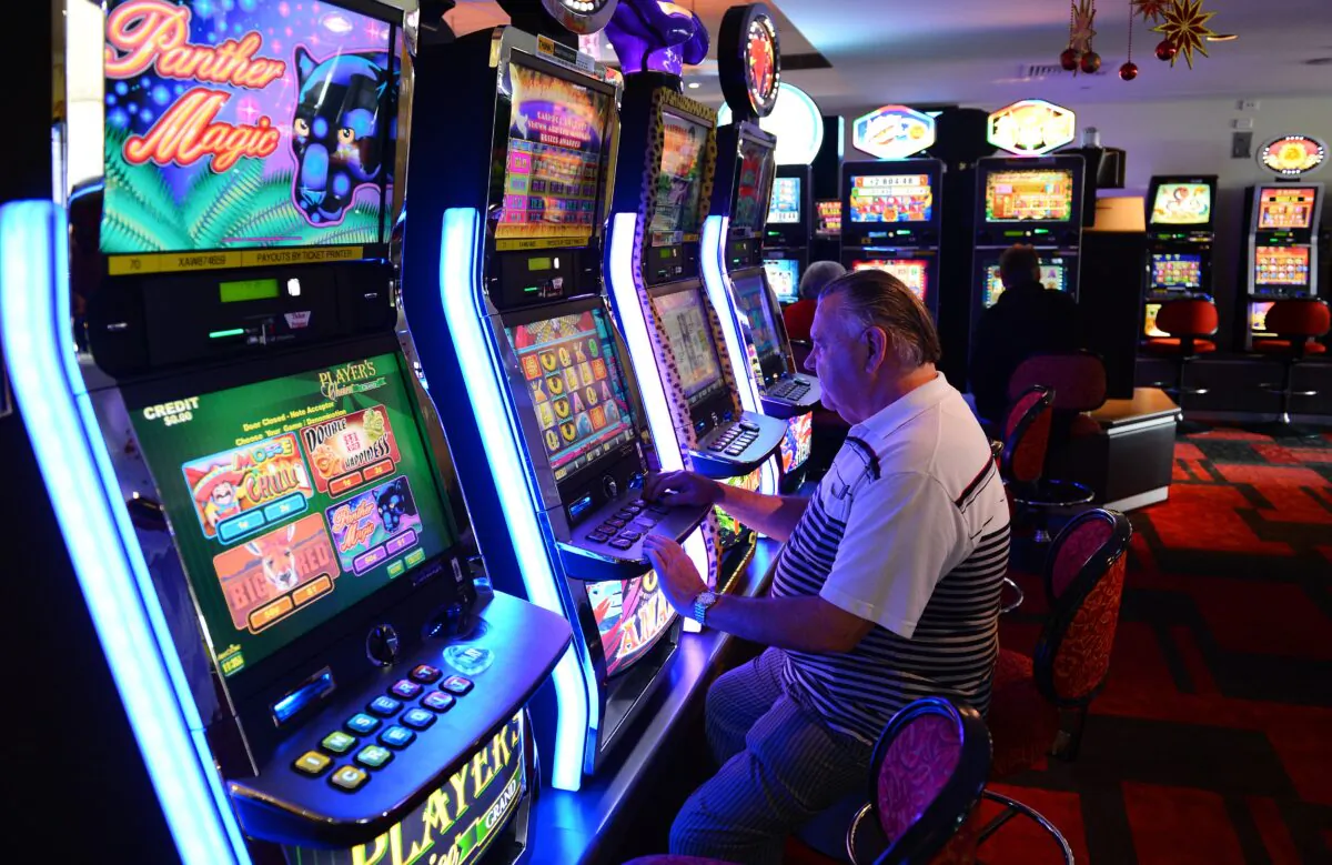 A retiree plays electronic poker machines at the Randwick Labor Club in Sydney, Australia, on Dec. 21, 2012. (William West/AFP via Getty Images)
