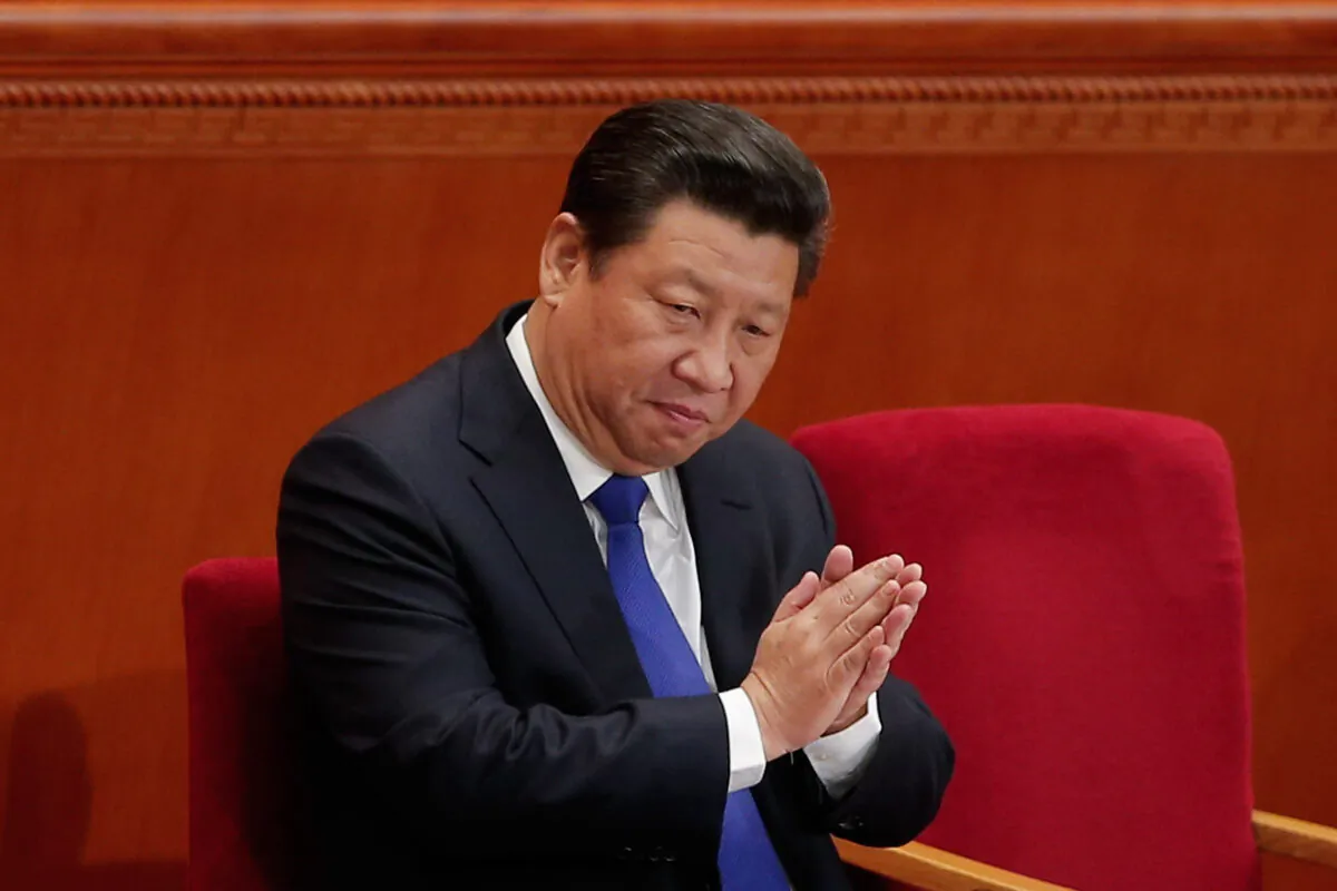 Party leader Xi Jinping applauds during the opening of the 3rd Session of the 12th National People's Congress in Beijing, China, on March 5, 2015. (Lintao Zhang/Getty Images)