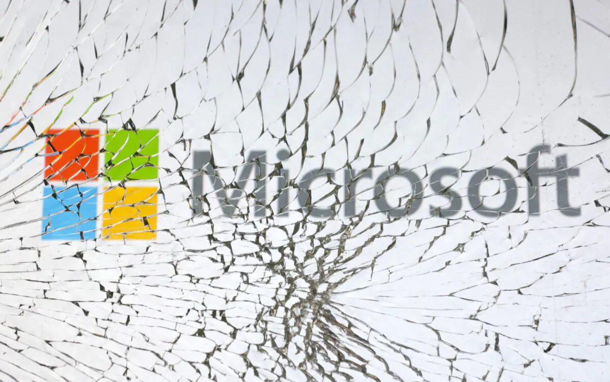 Microsoft logo is seen through broken glass in an illustration taken on Jan. 25, 2023. (Dado Ruvic/Illustration/Reuters)