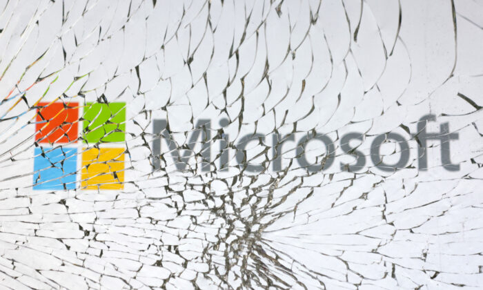 Microsoft logo is seen through broken glass in an illustration taken on Jan. 25, 2023. (Dado Ruvic/Illustration/Reuters)