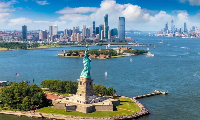 Panoramic aerial view of the Statue of Liberty, Jersey City, and Manhattan cityscape in New York City, N.Y. (Sergii Figurnyi/Shutterstock)