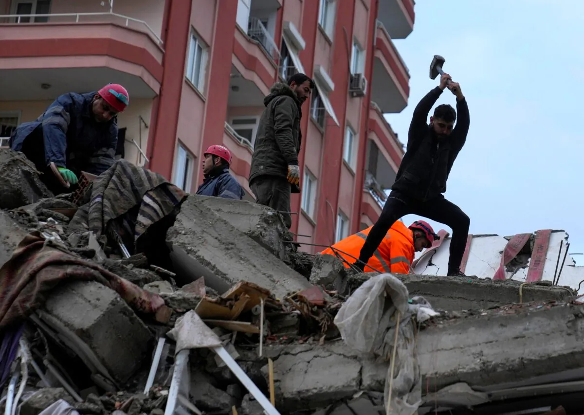 Emergency team members and others search for people in a destroyed building in Adana, Turkey, on Feb. 6, 2023. (Khalil Hamra/AP Photo)