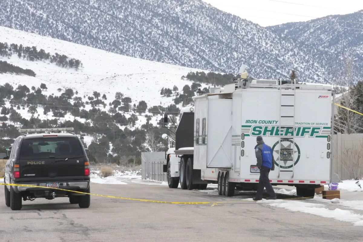 A police officer walks by a crime scene trailer that is sitting outside the home of Michael Haight in Enoch, Utah on Jan. 5, 2023. (George Frey/Getty Images)