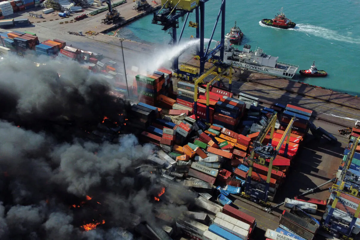 Smoke rises from burning containers at the port in the earthquake-stricken town of Iskenderun, Turkey, on Feb. 7, 2023. (Benoit Tessier/Reuters)