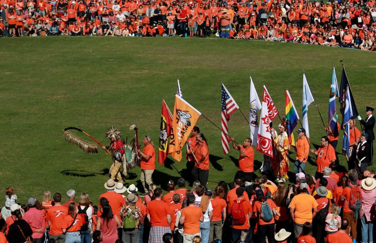 The grand entry takes place during the South Island powwow on National Truth and Reconciliation Day at Royal Athletic Park hosted by the Songhees Nation in Victoria, B.C., on Sept. 30, 2022. (The Canadian Press/Chad Hipolito)
