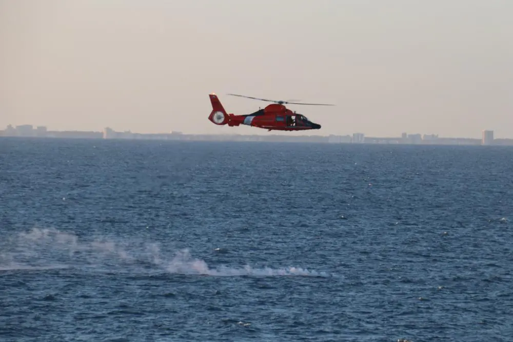 A U.S. Coast Guard helicopter flies over a debris field during recovery efforts of a high-altitude surveillance balloon on Feb. 4, 2023. (U.S. Navy photo by Lt. j.g. Jerry Ireland)
