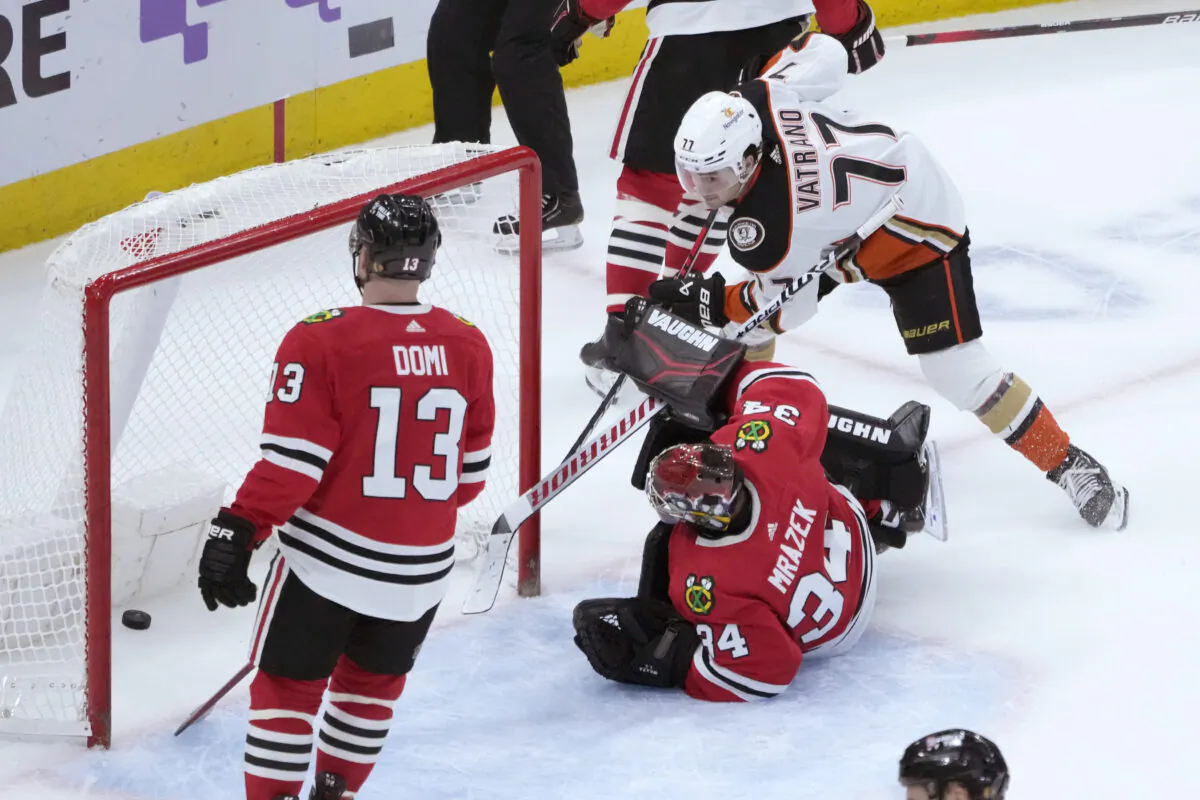 Anaheim Ducks' Frank Vatrano scores the game winning goal past Chicago Blackhawks goaltender Petr Mrazek (34) as Max Domi watches during the overtime period of an NHL hockey game in Chicago on Feb. 7, 2023. (Charles Rex Arbogast/AP Photo)