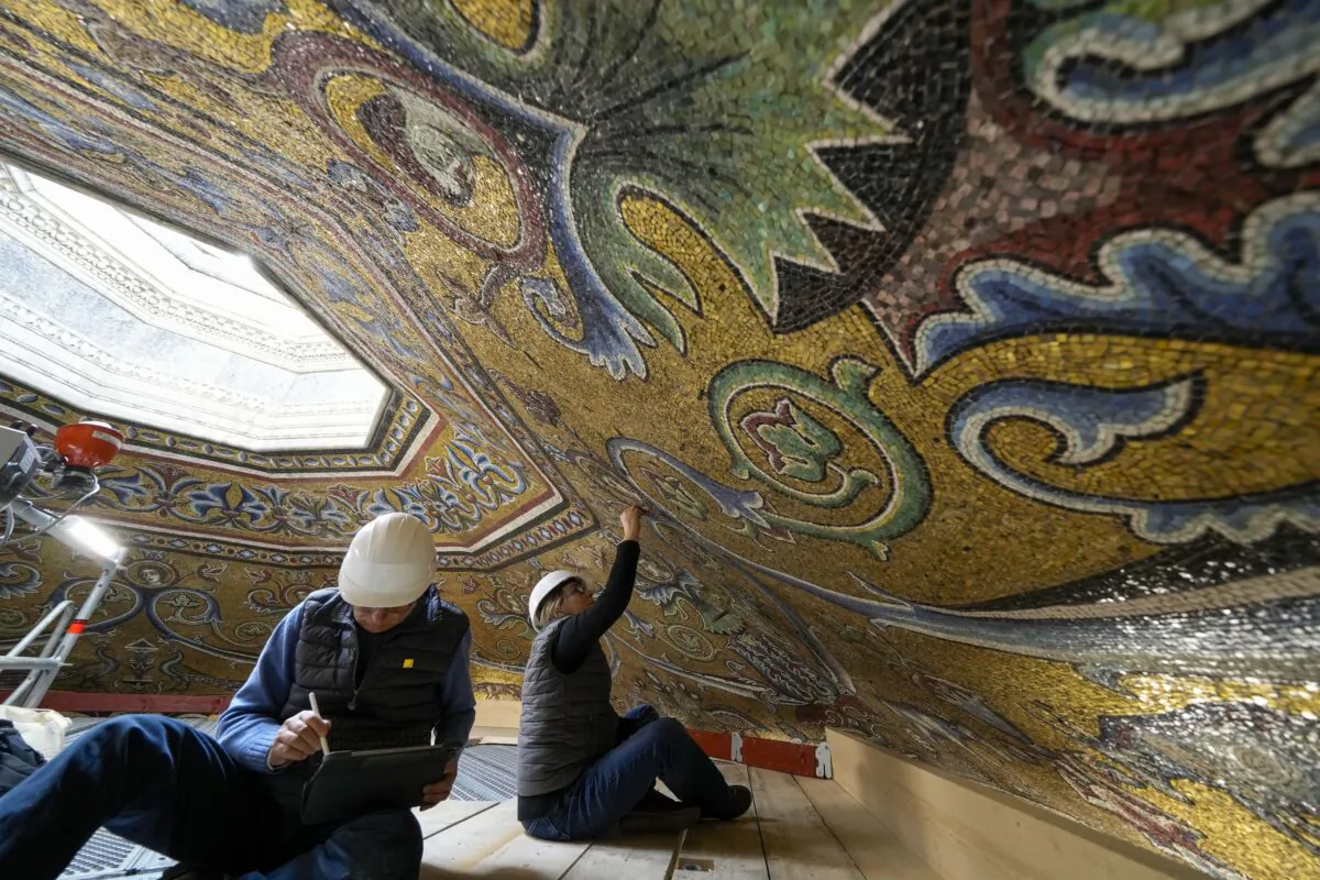 Restorers Chiara Zizola (R) and Roberto Nardi work on the restoration of the mosaics that adorn the dome of one of the oldest churches in Florence, St. John's Baptistery, in Florence, central Italy, on Feb. 7, 2023. (Andrew Medichini/AP Photo)