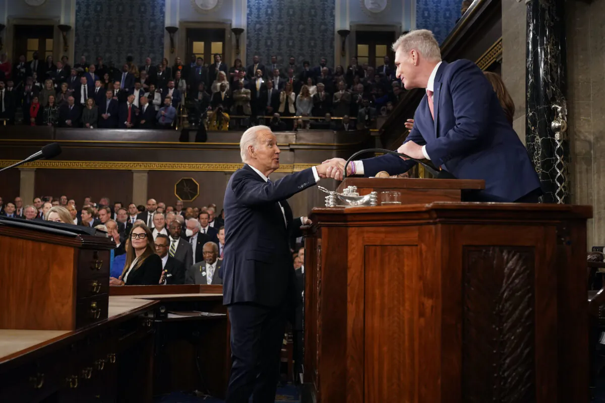 U.S. President Joe Biden shakes hands with House Speaker Kevin McCarthy (R-Calif.) before delivering the State of the Union address to a joint session of Congress in the House Chamber of the U.S. Capitol on Feb. 7, 2023. (Jacquelyn Martin-Pool/Getty Images)