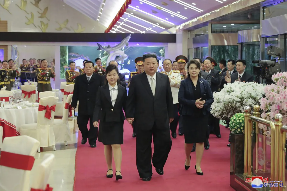 North Korean leader Kim Jong Un (C) with his wife Ri Sol Ju (R) and his daughter attend a feast to mark the 75th founding anniversary of the Korean People’s Army at an unspecified place in North Korea on Feb. 7, 2023. (Korean Central News Agency/Korea News Service via AP)