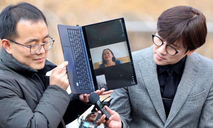 Vietnamese woman Nguyen Thi Thanh on a computer monitor as she speaks outside the court at the Seoul Central District Court in Seoul, South Korea, on Feb. 7, 2023. (Ryu Young-suk/Yonhap via AP)