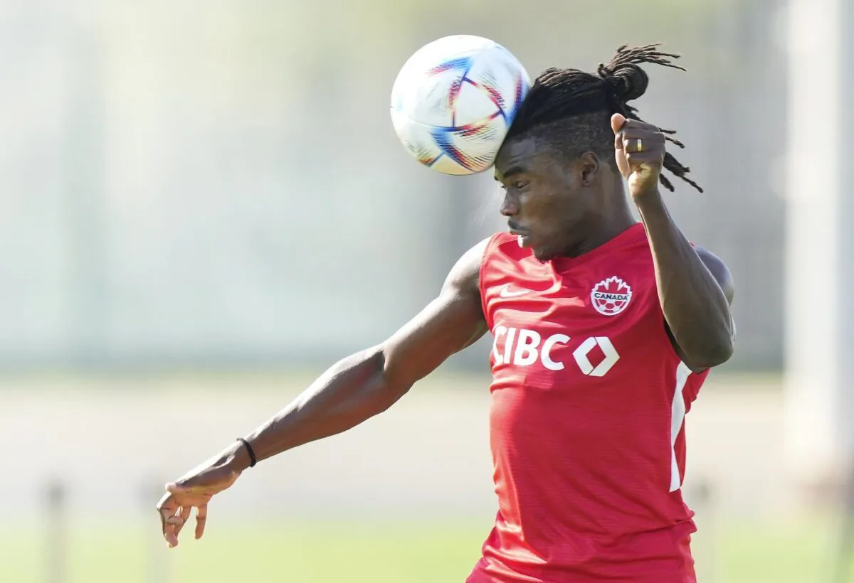 Canada defender Sam Adekugbe heads the ball in a drill during practice at the World Cup in Doha, Qatar during on Nov. 24, 2022. (The canadian Press/Nathan Denette)