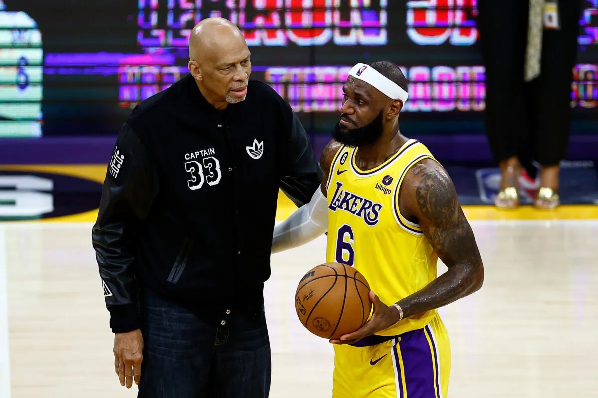 Kareem Abdul-Jabbar ceremoniously hands LeBron James (6) of the Los Angeles Lakers the ball after James passed Abdul-Jabbar to become the NBA's all-time leading scorer, surpassing Abdul-Jabbar's career total of 38,387 points against the Oklahoma City Thunder at Crypto.com Arena in Los Angeles on Feb. 7, 2023.(Ronald Martinez/Getty Images)