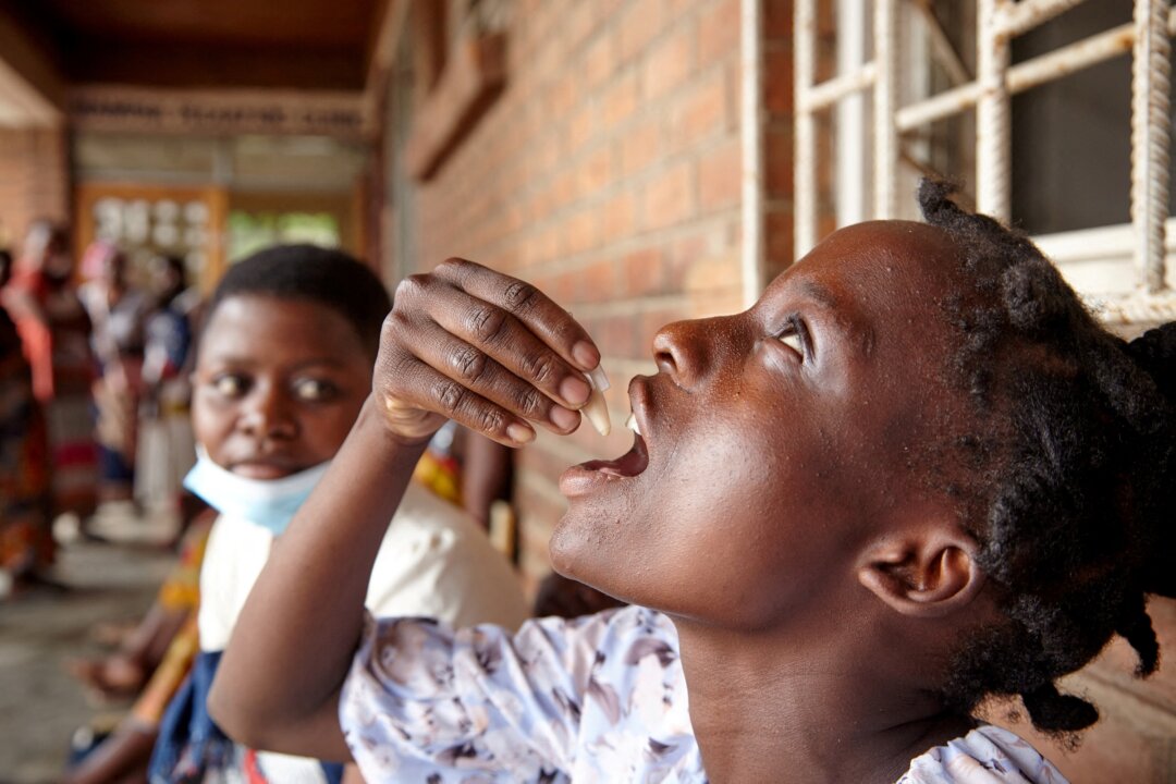 Eliza Tangwe, 18, takes a dose of oral cholera vaccine at a health center in response to the latest cholera outbreak in Blantyre, Malawi, on Nov. 16, 2022. (Eldson Chagara/Reuters)