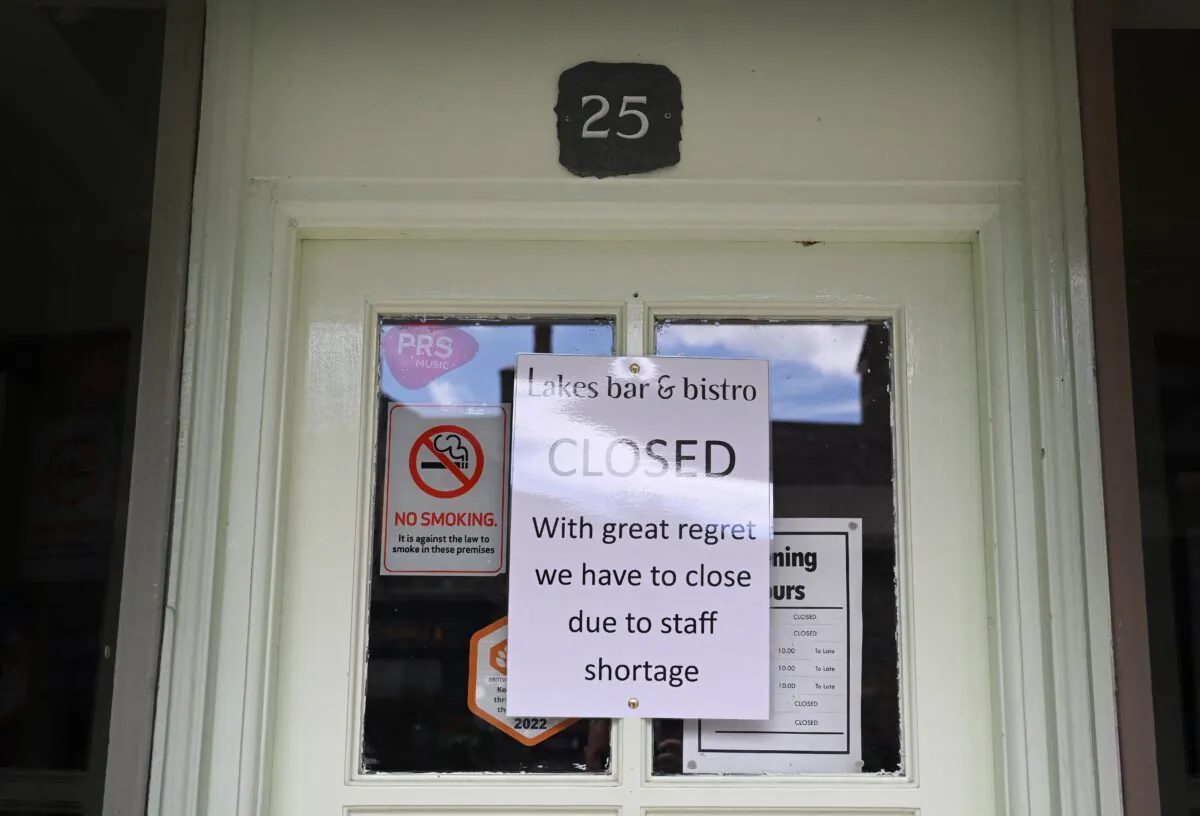 A closing message owing to lack of staff displayed  on the window of a shop, in the town centre of Keswick, in the Lake District, northwest England, on June 20, 2022. (Paul Ellis/AFP via Getty Images)